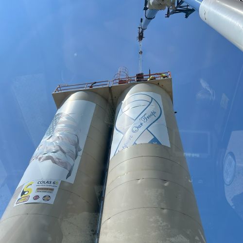 P"hoto of a crane working on silos